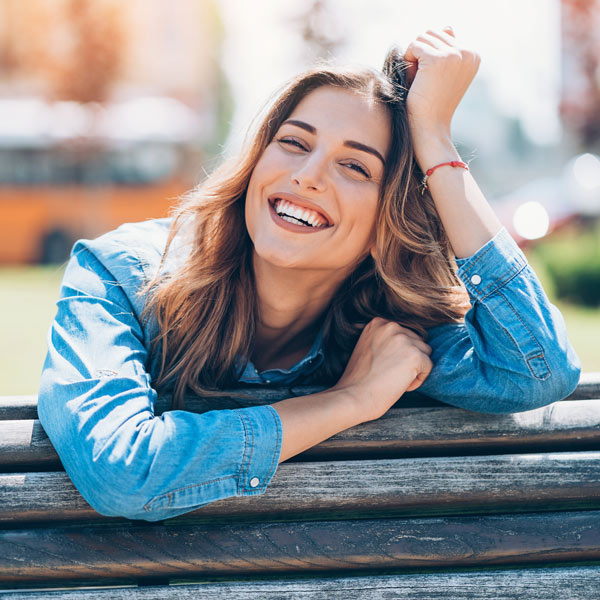 Smiling woman after bone grafting treatment in Brookfield, WI