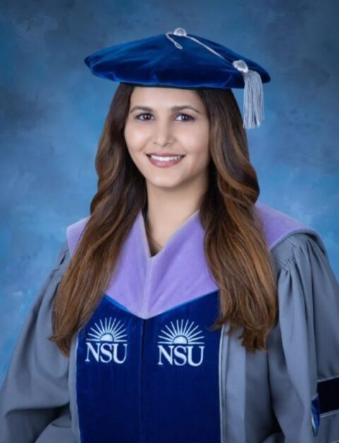 A smiling woman in academic regalia, having the "NSU" logo, featuring Dr Lovleen Sidhu in Brookfield