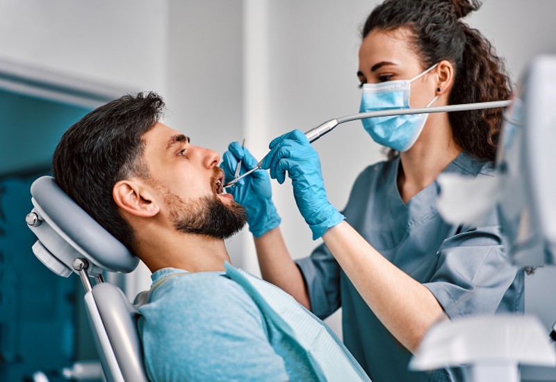 A patient receiving care from a dentist during a restorative dental procedure in Brookfield, WI