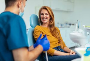 A dentist explains the impact of hormonal changes on oral health to a patient in Brookfield, WI